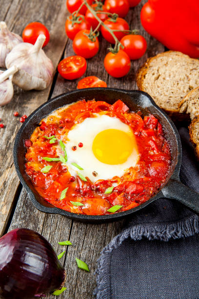 istock Shakshuka Scrambled eggs with tomatoes and vegetables. Breakfast. In the plate. Top view. Flat lay composition Free copy space. 1217623184