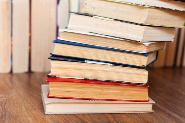 istock stack of old book on wooden table, education concept background, many books piles with copy space for text 1217626033