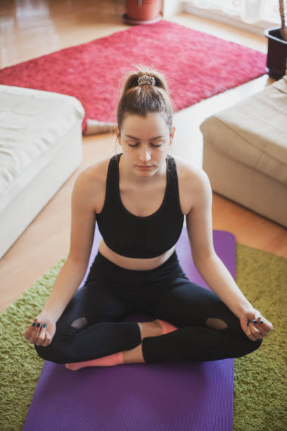istock Young women exercising at home with online help on laptop 1217626350