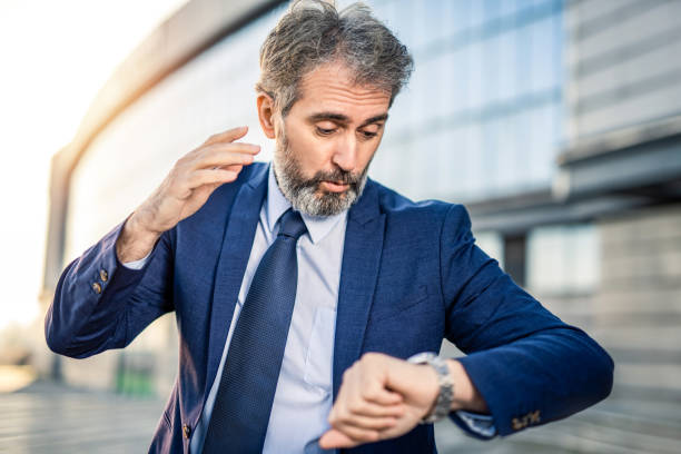 istock Worried mature businessman in a hurry checking time. 1217626957