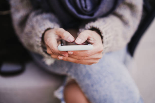 istock unrecognizable woman using mobile phone outdoors. lifestyle and technology concept 1217627023