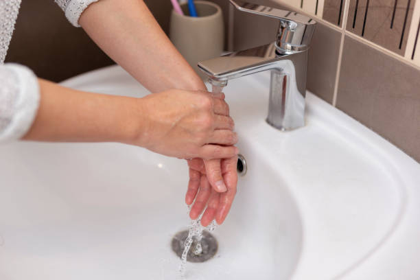 istock Woman washing hands 1217629073