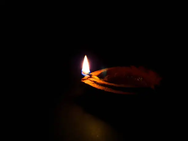 An oil lamp lit as an offering to hindu for worship with selective focus.