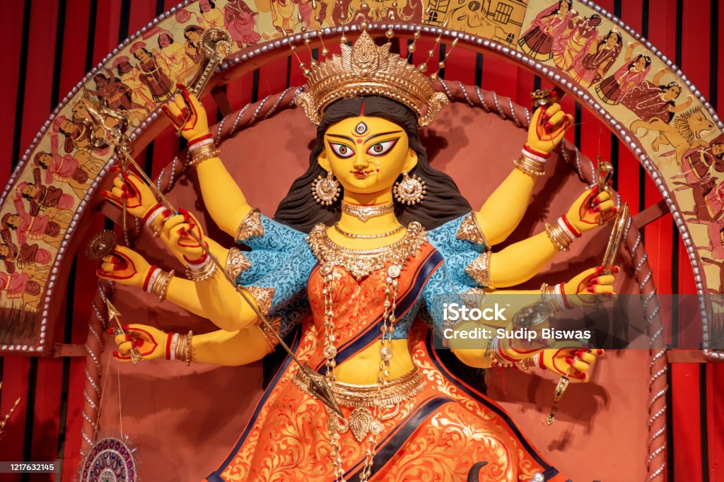 Goddess Durga idol at decorated Durga Puja pandal, shot at colored light, at Kolkata, West Bengal, India. Durga Puja is biggest religious festival of Hinduism and is now celebrated worldwide. Durga Stock Photo
