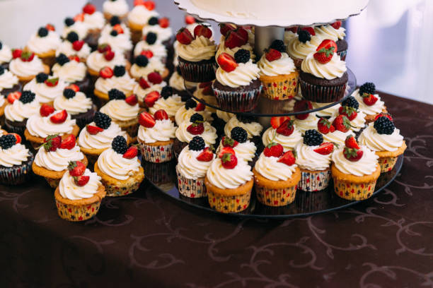 istock Wedding cake and cupcakes with berries. Cream cakes. 1217633881