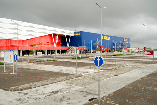 Faro, Portugal - April 7, 2020: Empty parking lot in front of the biggest shopping mall in Algarve - MAR Shopping Mall, Designer Outlet and Ikea - due to emergency state caused by coronavirus pandemic