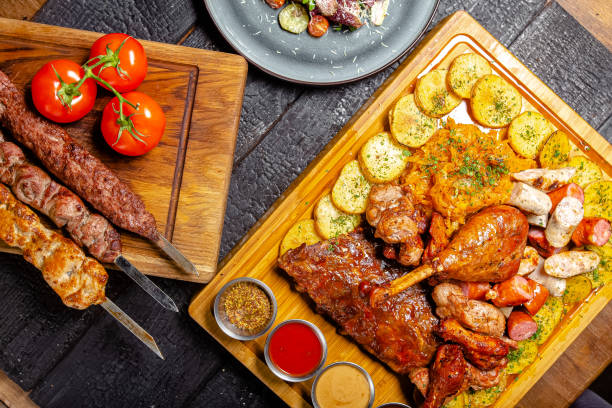 istock background black burnt charred forest, structure, shot from above, meat kebab, fried leg, turkey thigh, rustic potatoes, sauce, pork rib, on a wooden cutting board 1217633957