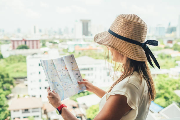 istock Confused female with destination map looking for sightseeing 1217634155