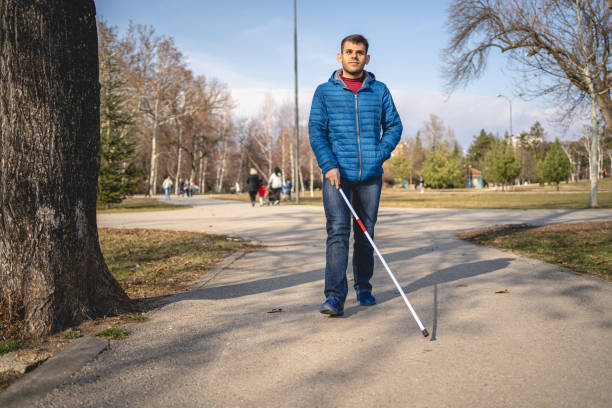 istock Visually impaired young man walking with a help of walking cane 1217634983
