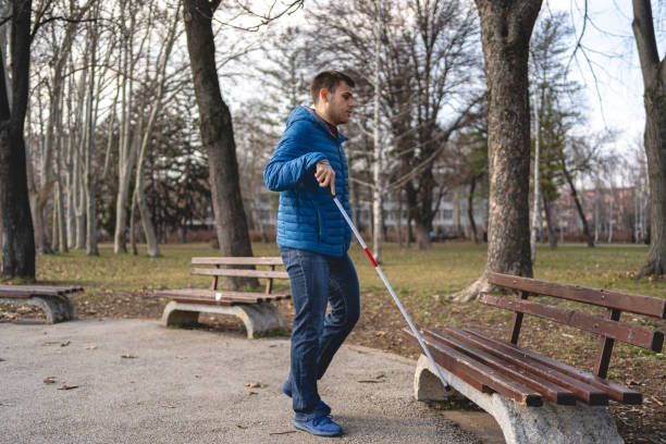 istock With a help of walking cane blind man found a bench to sit and relax 1217635184