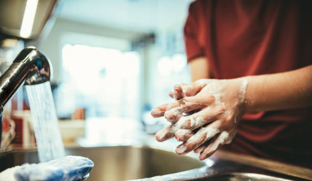 istock COVID-19, Teenager's hands washing during lockdown 1217635420