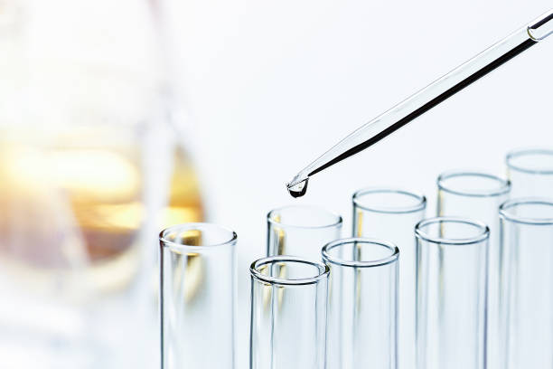 Glass pipette with a drop of liquid stock photo