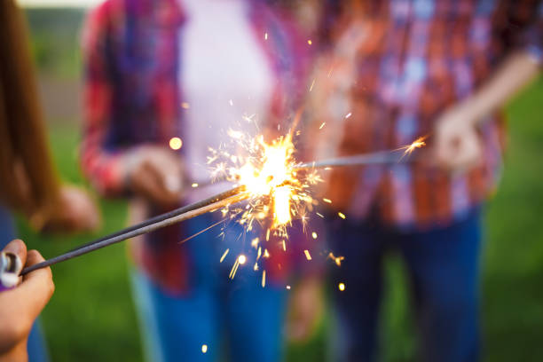 istock Friends holding sparklers in summer park. 1217635917