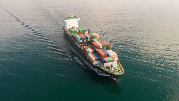 istock Large container ship at sea. Aerial top view of cargo container ship vessel import export container sailing. 1217637079