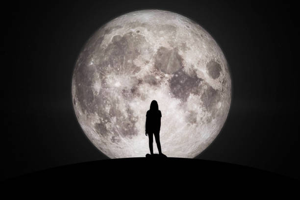 silhouette of man and women  looking at the moon with hope fulfillment in love. elements of this image furnished by nasa. - valentine imagens e fotografias de stock