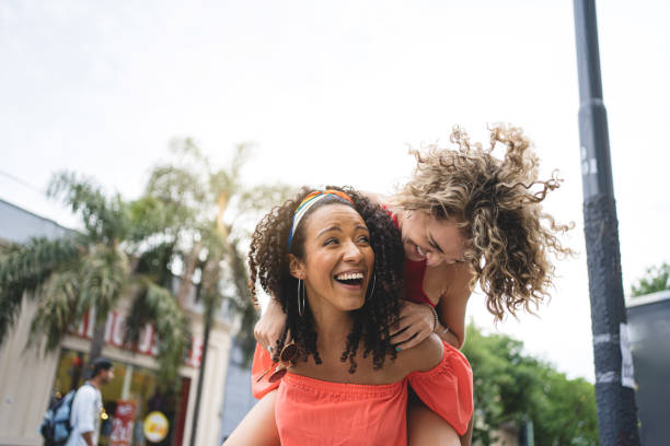 istock Modern woman piggyback her cheerful friend 1217637367