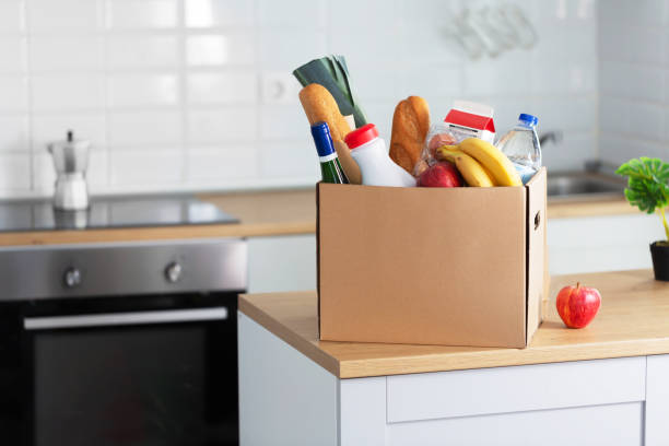 istock Safe home delivery. A box of food on the modern kitchen, horizontal 1217637401