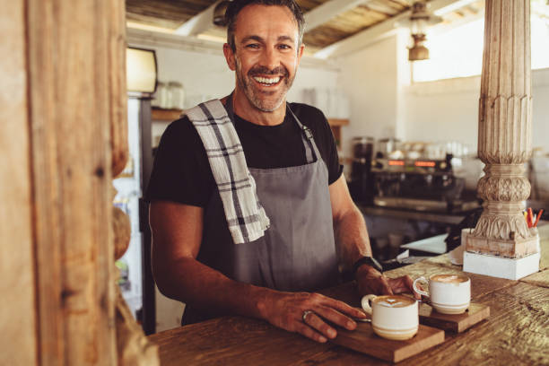 istock Male barista serving coffee to customers 1217637578