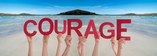 istock People Hands Holding Word Courage Means Do Not Give Up, Ocean Background 1217637975