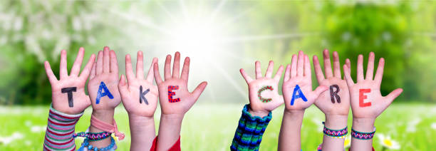 istock Children Hands Building Word Take Care, Grass Meadow 1217638595