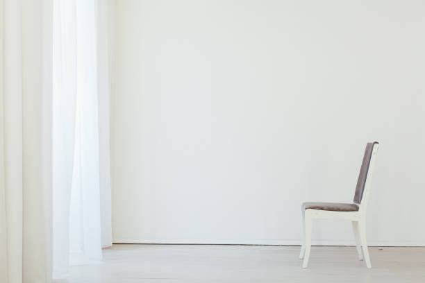 istock gray chair in an empty white interior room 1217639086