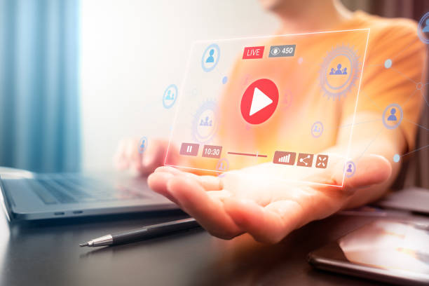 istock Attractive Asian man using Laptop computer to watching and control live streaming video on a social network. Watch and enjoy online multimedia entertainment content while staying at home. 1217640752