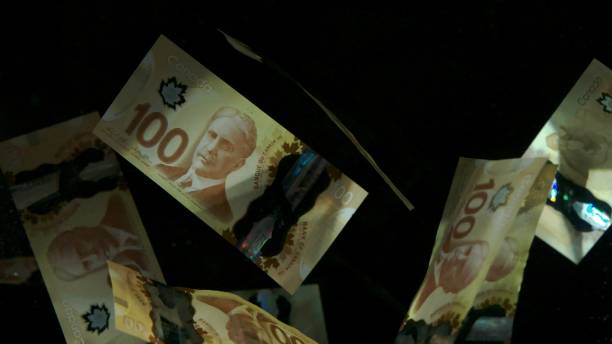 istock Falling flying american canadian dollar banknotes on a black background. High quality falling Dollar banknotes 1217641342