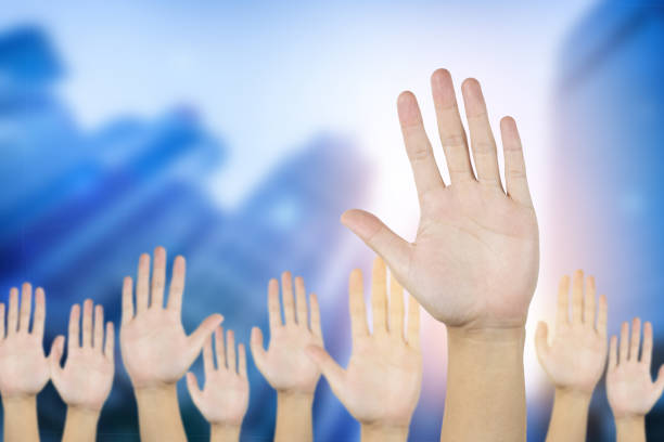 Two hands are almost touching for handshake in silhouette