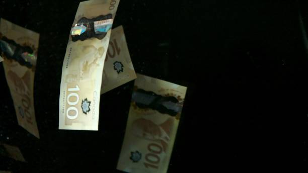 istock Falling flying american canadian dollar banknotes on a black background. High quality falling Dollar banknotes 1217641647