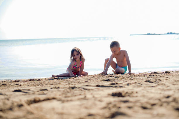 istock Kids are playing on a beach 1217642355