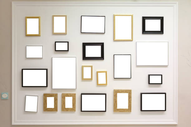 istock Many photo frames are hanging on the wall. Photo frames with a white background, you can insert your own pictures. 1217642380