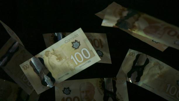 istock Falling flying american canadian dollar banknotes on a black background. High quality falling Dollar banknotes 1217642538