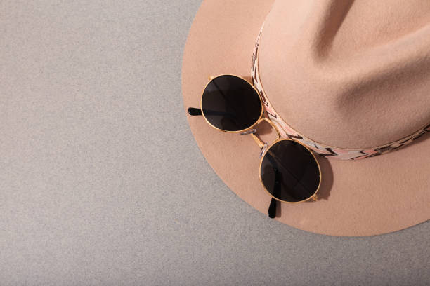 istock Beige felt hat with round sunglasses on grey background - Image 1217642661