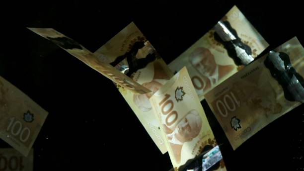 istock Falling flying american canadian dollar banknotes on a black background. High quality falling Dollar banknotes 1217642744