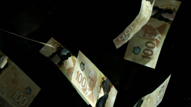 istock Falling flying american canadian dollar banknotes on a black background. High quality falling Dollar banknotes 1217642765