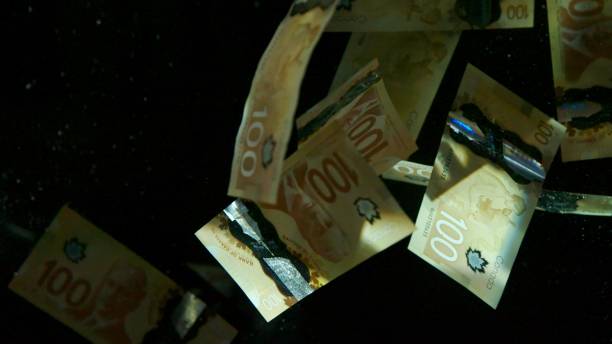 istock Falling flying american canadian dollar banknotes on a black background. High quality falling Dollar banknotes 1217642810