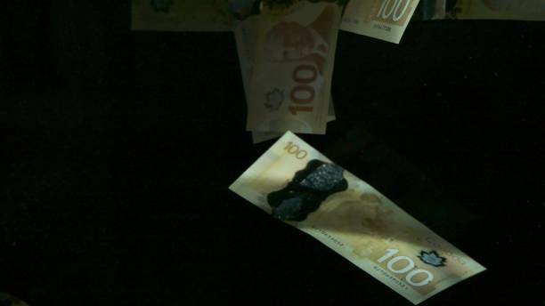 istock Falling flying american canadian dollar banknotes on a black background. High quality falling Dollar banknotes 1217642867