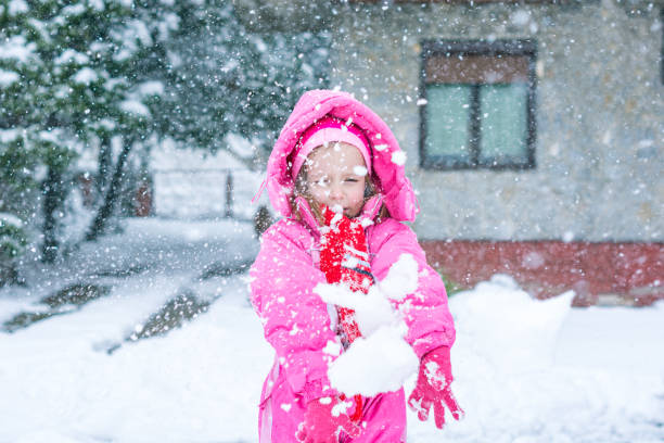 istock Little girl playing on the snow 1217645194