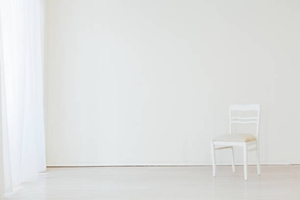 istock one chair in the interior of an empty white room 1217645370