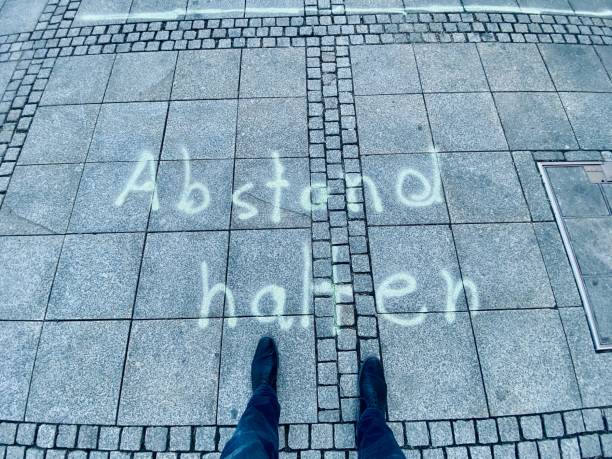 istock Keep distance text on the market square, German language: Keeping distance 1217645423