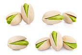 Collection of delicious pistachios on white