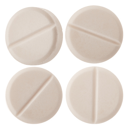 White round medical pills on white background