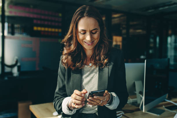 istock Woman entrepreneur using a phone in office 1217646551