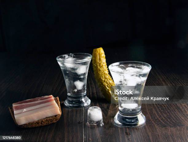 https://media.istockphoto.com/id/1217648380/photo/vodka-in-glasses-and-ice-on-an-old-wooden-table-closeup.jpg?s=612x612&w=is&k=20&c=8xAamaQImnycIplC3QXMlX5op5ldxFMdeAkuWXk1wso=