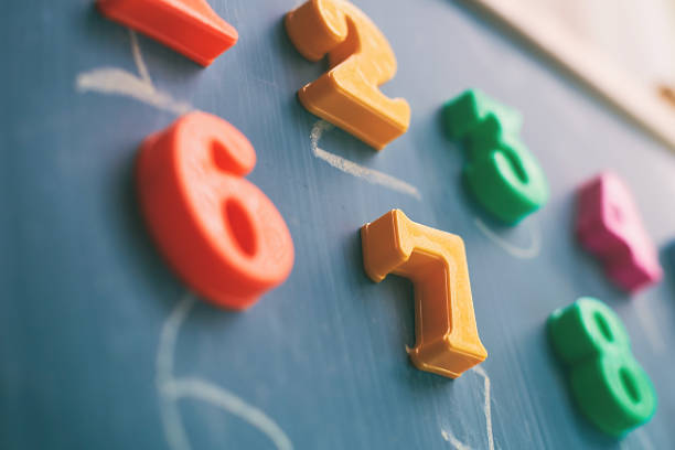 istock Learning numbers on a blackboard with colorful magnets and handwriting on blackboard during homeschooling at quarantine 1217649078