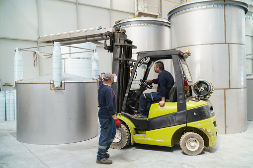 Two workers are working with forklift