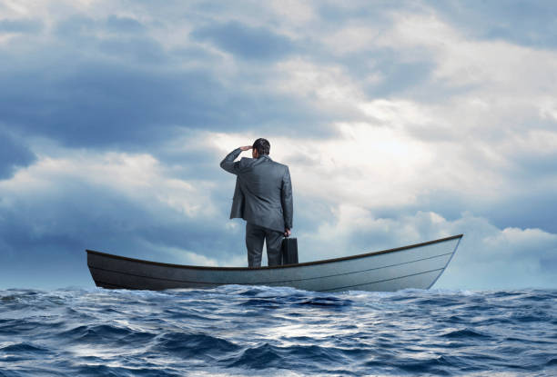 istock Stranded Businessman In Row Boat Searches For Help 1217649473