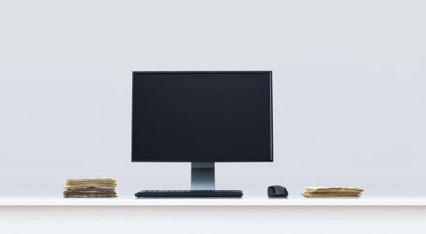 istock Clean white office desk in with computer and banknotes money. 1217649680