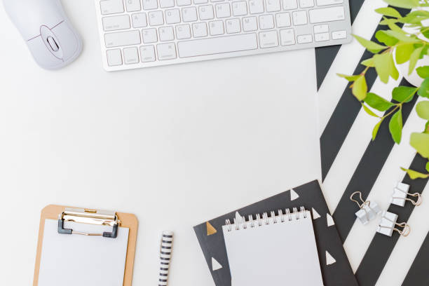 istock Flat lay blogger or freelancer workspace with a keyboard, branches with green leaves, office supplies on a light background 1217649701