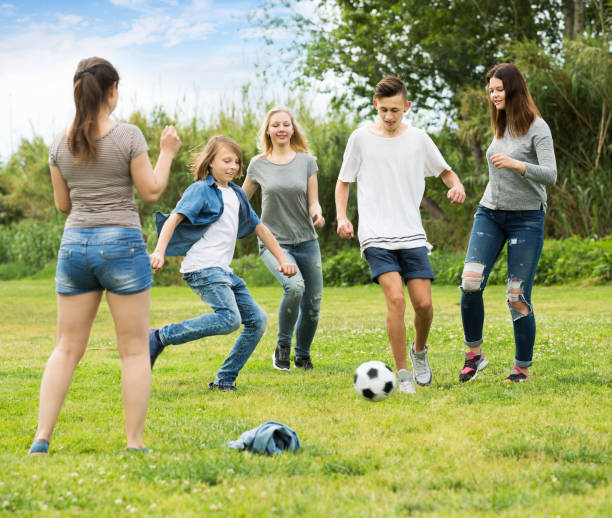 istock Teenagers friends running with ball 1217650577